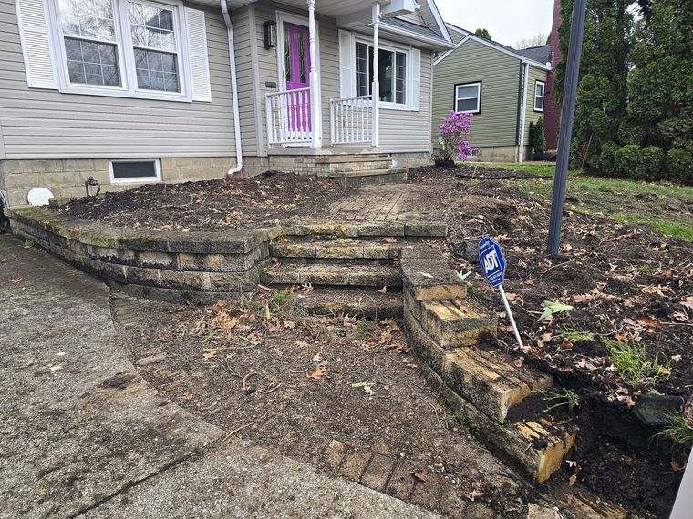 Front entry before: rotting timber retaining walls and crumbling concrete steps